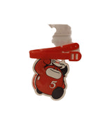 Load image into Gallery viewer, Red car-shaped keychain in a clear plastic bag on a beige background